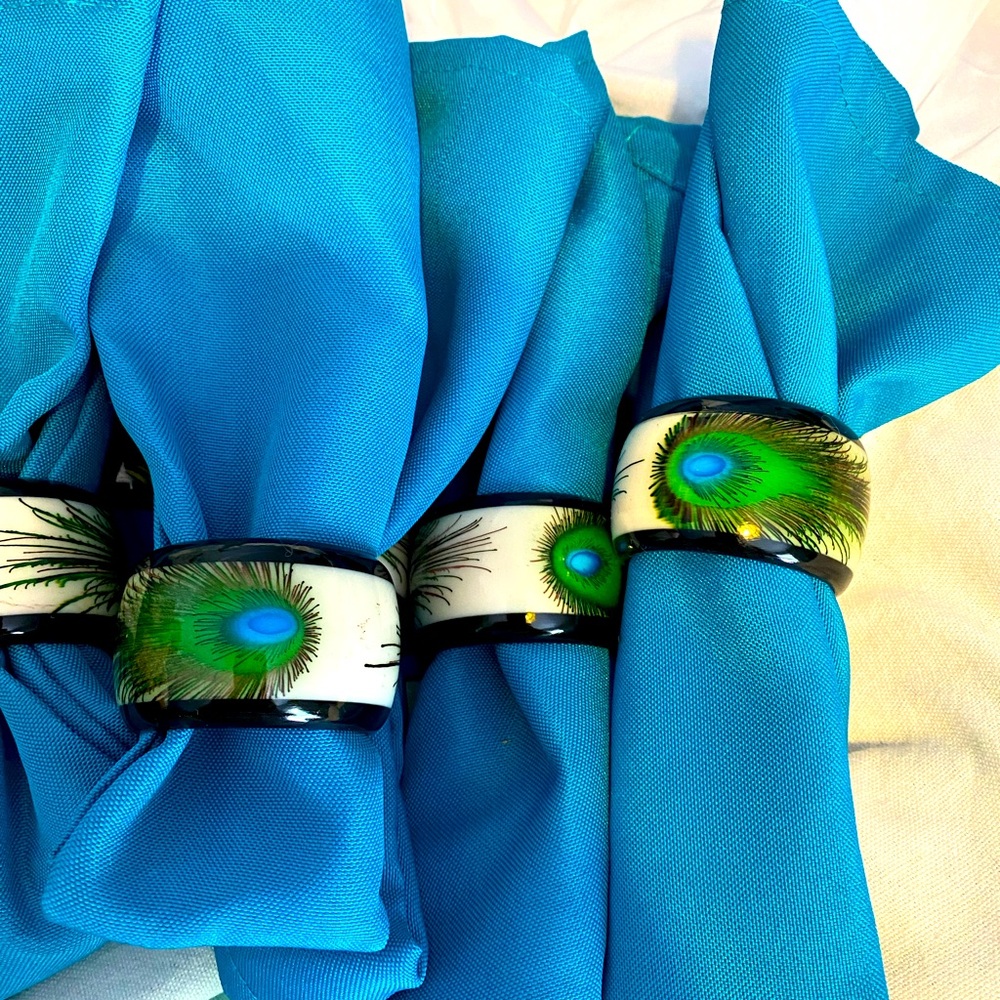 Lot of peacock items 2 figures 2 table runners 8 cloth napkins 8 napkin rings